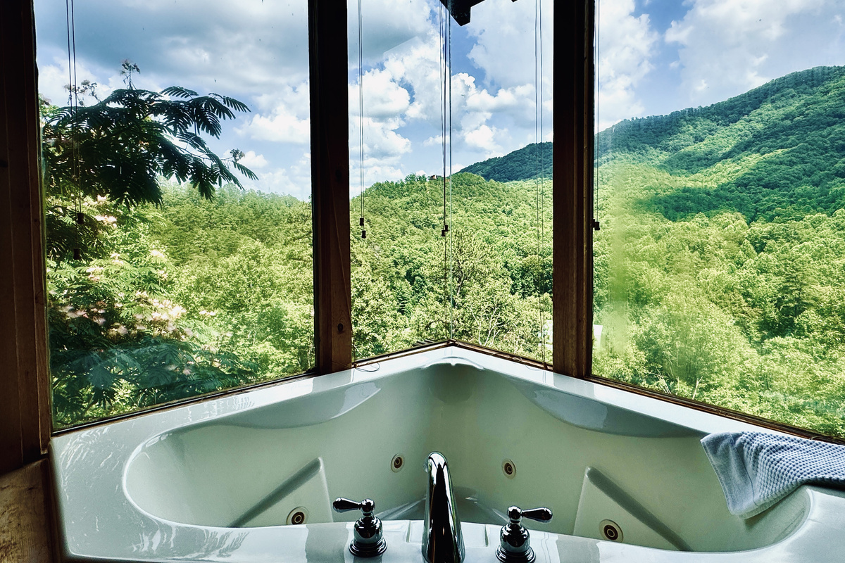 Mountain View Room view from bathtub! Dramatic corner windows on back side of cabin.