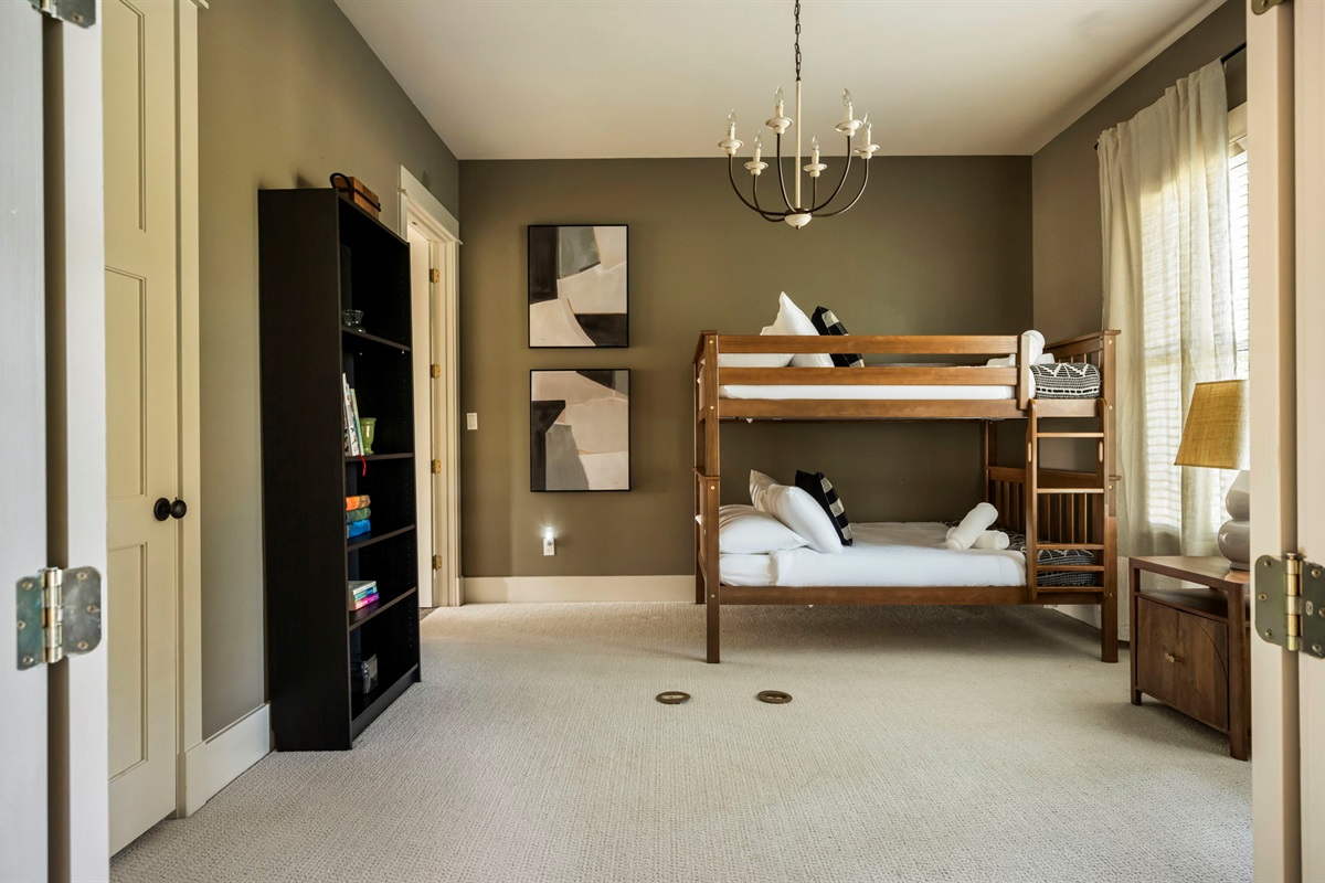 A bookshelf and lamp provide a cozy touch for reading and relaxation.