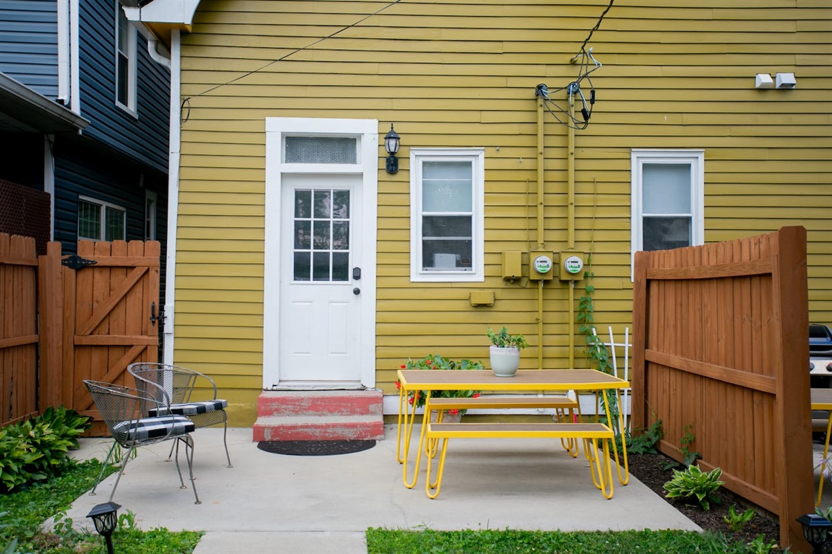 Private rear patio with outdoor dining and keyless entry, just off the kitchen — a convenient, secure setup for everyday living, longer stays, and easy in-and-out access.