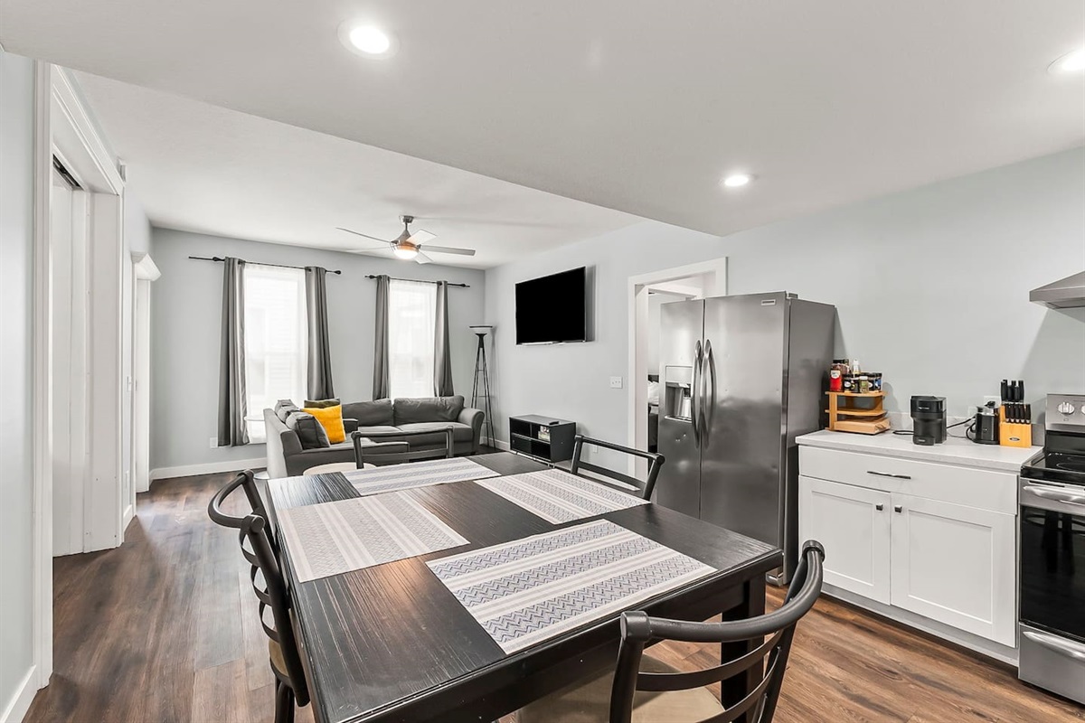 Open-concept dining space overlooking the living room, ideal for shared meals and relaxed gatherings.