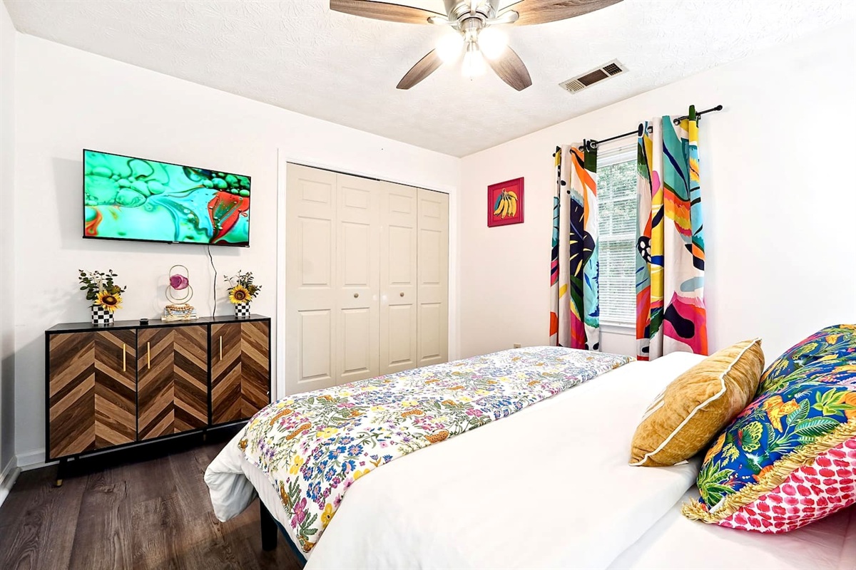 Bedroom 4 is located upstairs and features a king bed and TV. This room does not have a private en-suite bathroom but has access to a shared full bathroom on the second floor.