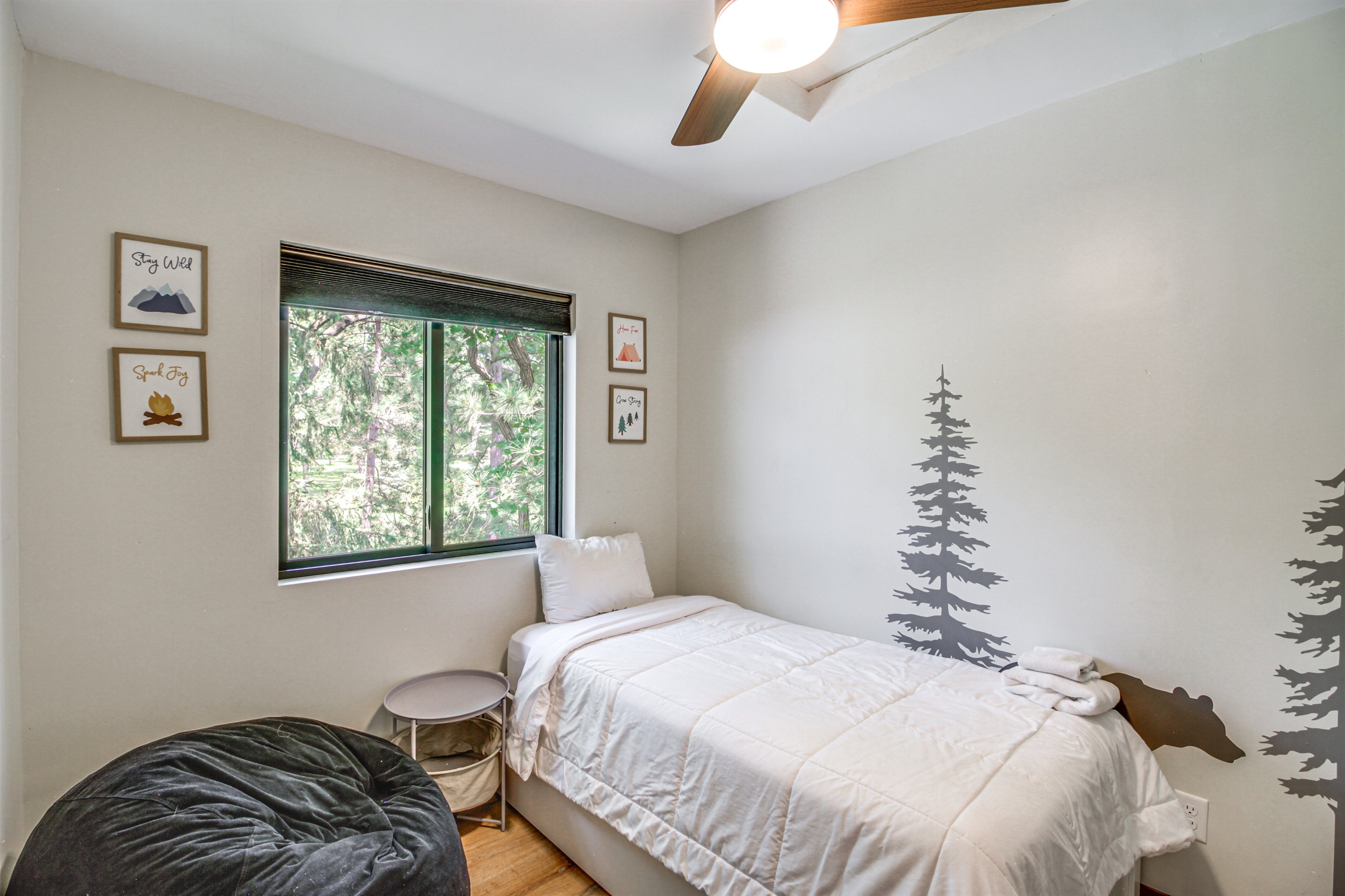 Twin bedroom with woodland décor—perfect for kids or solo travelers