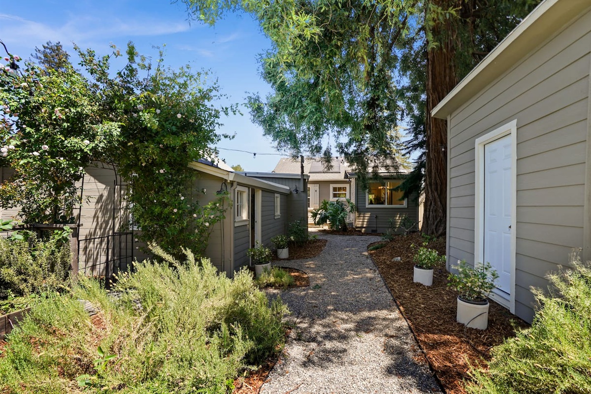 Private backyard retreat featuring a hot tub, fire pit, and multiple outdoor seating areas perfect for relaxing nights.