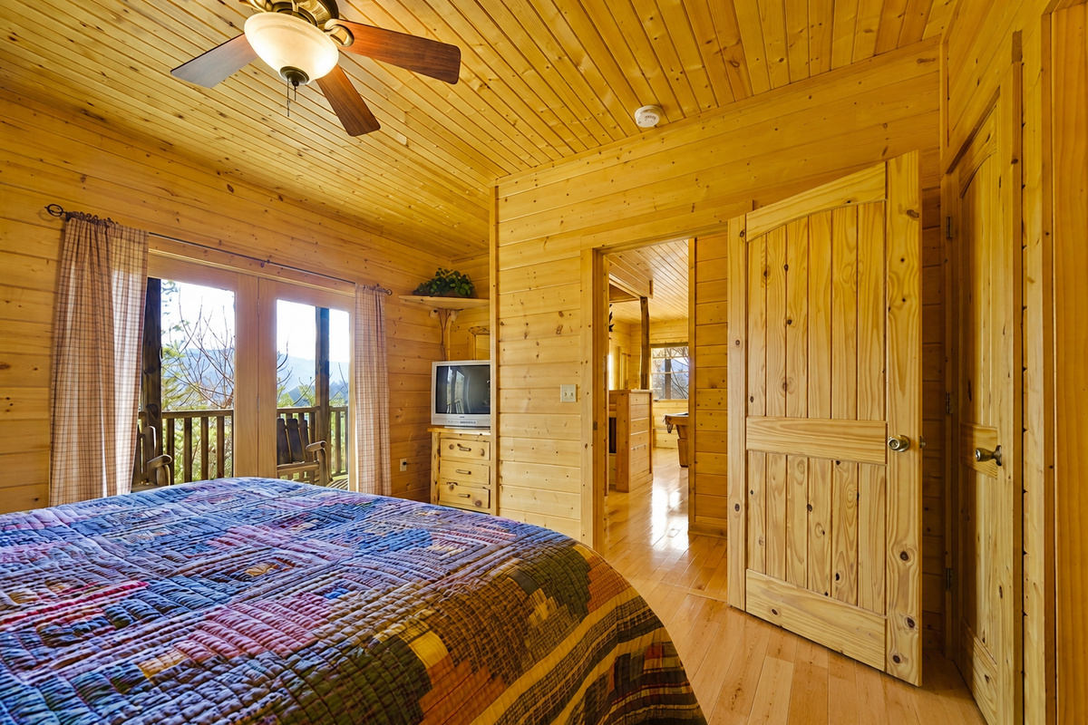 Bedroom #3 - Step from your cozy bed onto your own private deck and greet the morning mountain air. With natural light and wood accents, this serene suite is made for slow mornings and quiet moments.