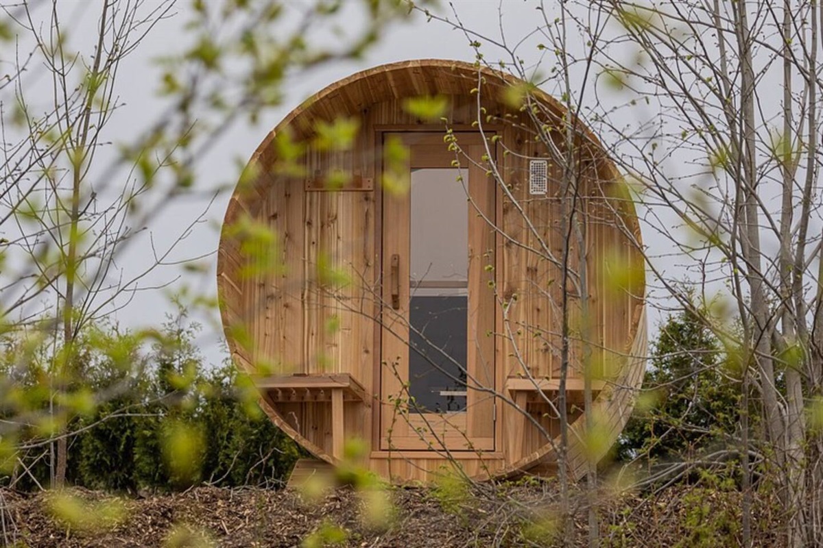 Discover the ultimate in relaxation and luxury with this stunning outdoor sauna, perfectly situated within a beautifully landscaped backyard oasis.