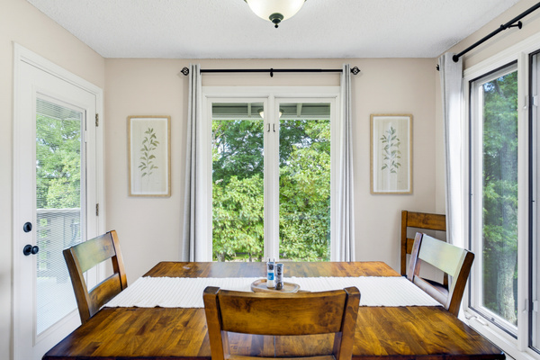 The dining area is surrounded with windows bringing the beauty of surrounding landscape right to the table.