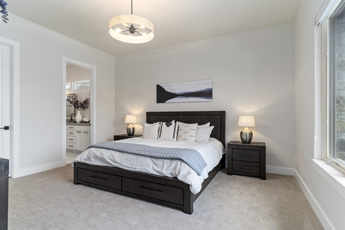 A comfortable primary bedroom with a king bed and peaceful, relaxing atmosphere.