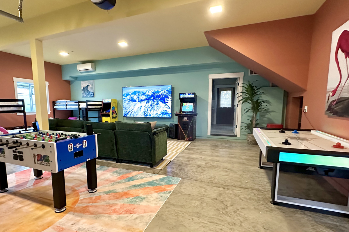 The Flamingo Fun Room sits right at the bottom of the stairs with its own outside entry — the kids' zone stays a floor away from the grown-ups, especially handy if you book Side B too.