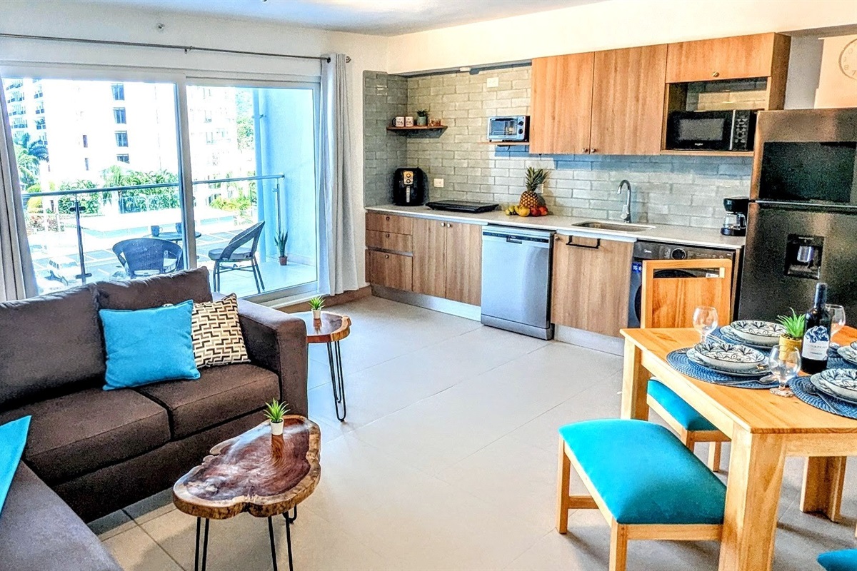 Comfortable combo room with lounge, dining table, and kitchen.