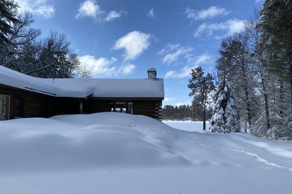Occasionally we get enough snow that the cabin starts to be hard to see. We have plenty of room for your snowmobiles and are located right off the main Hiawatha trail.