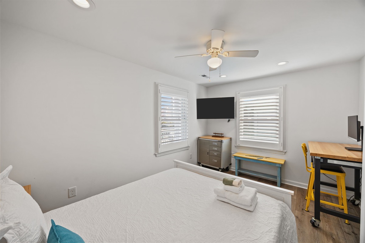 Wall-mounted TV with convenient storage and seating nearby