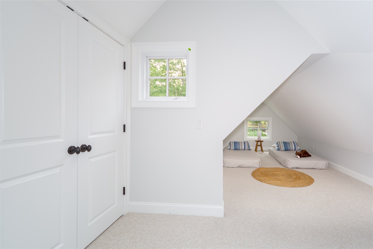 With a queen and two twin beds, this bedroom  offers space and flexibility for guests of all ages.