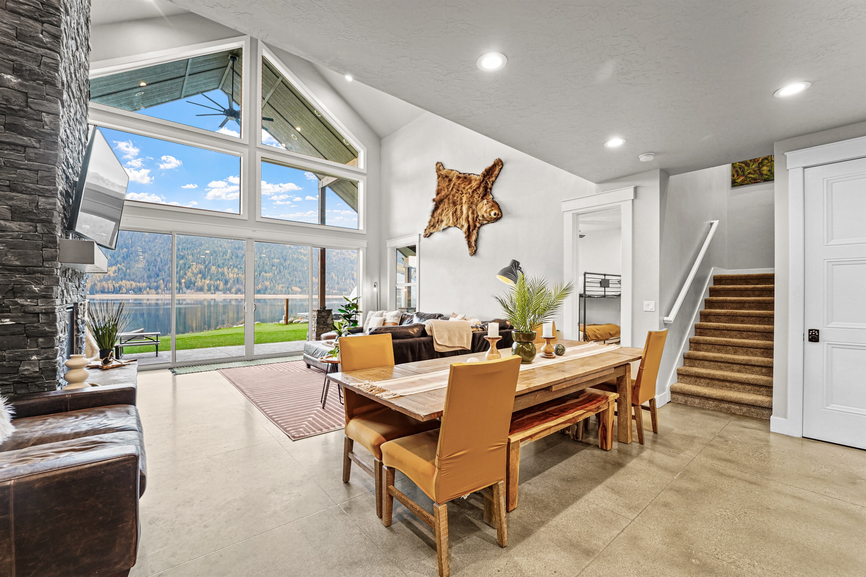 Vaulted ceilings and huge windows frame your stunning lake view