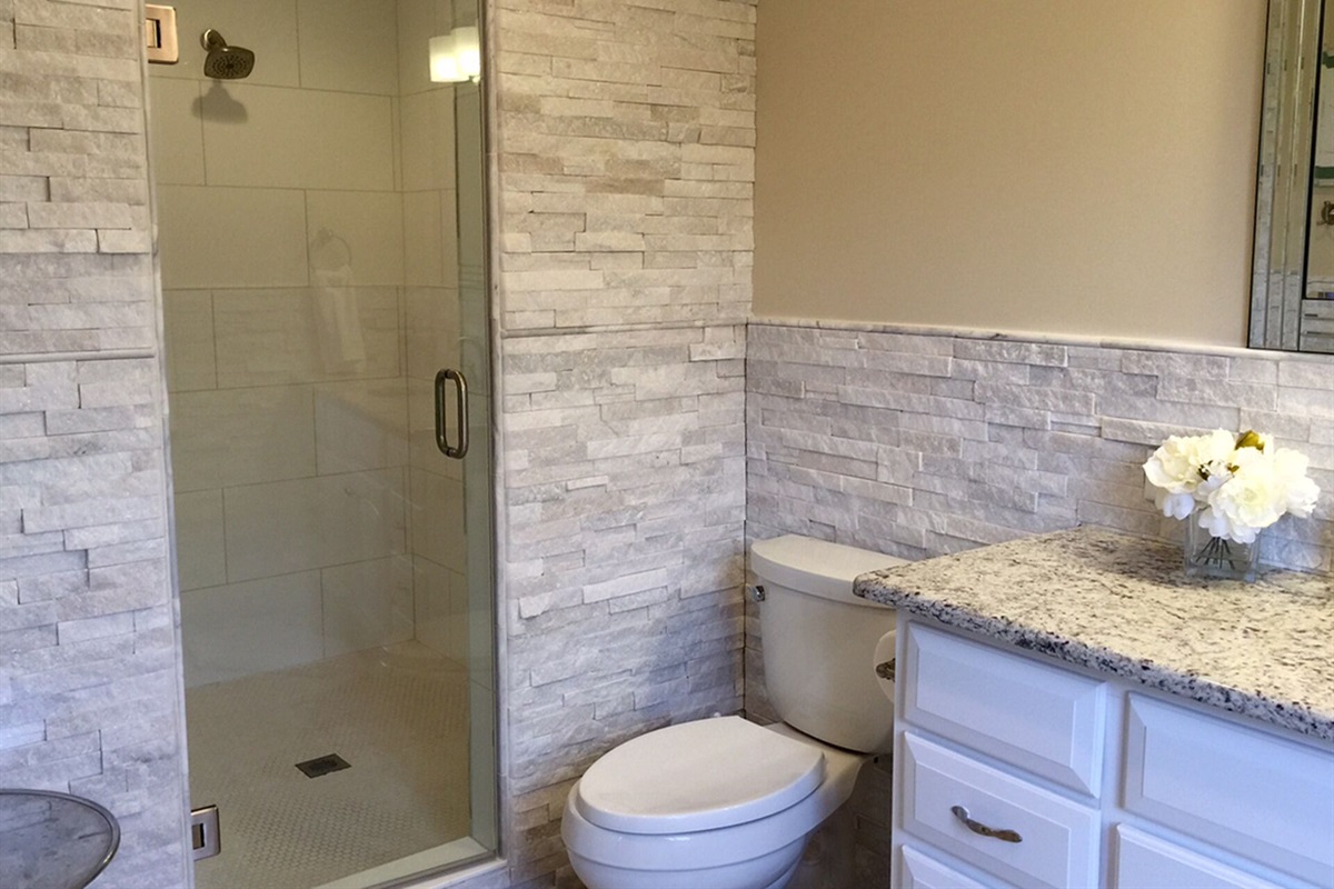 Double queen bedroom has private bath with large shower stall.