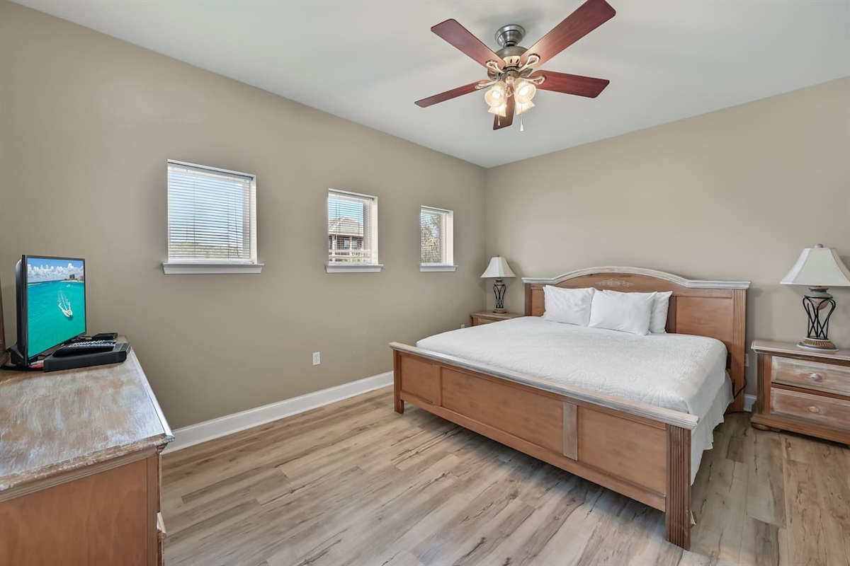 BEDROOM #2 + BATHROOM #2: King Bed with night stands, dresser, and TV. This bedroom has a private bath