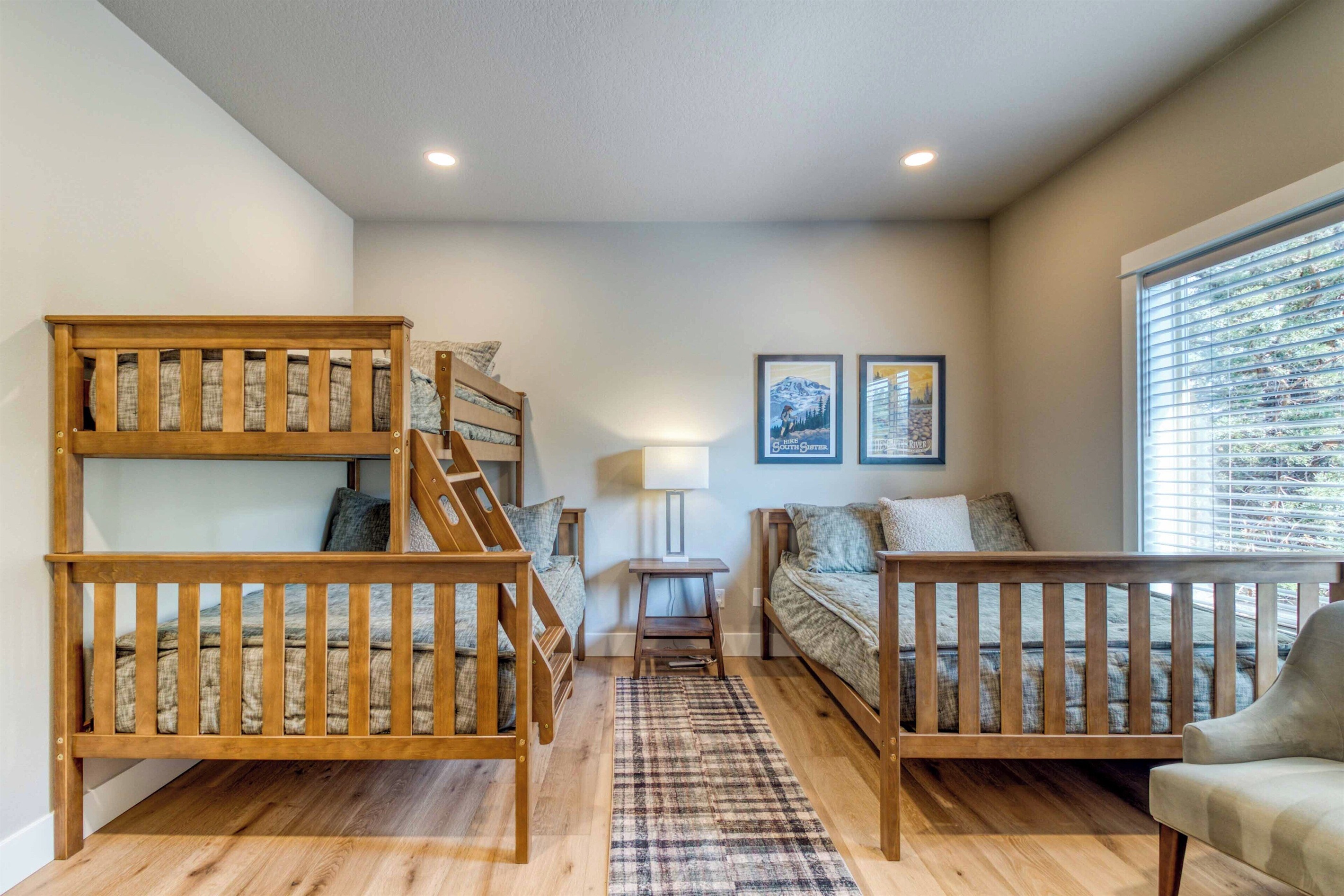 Our warm bunk room features two full beds and an upper twin with cozy bedding.