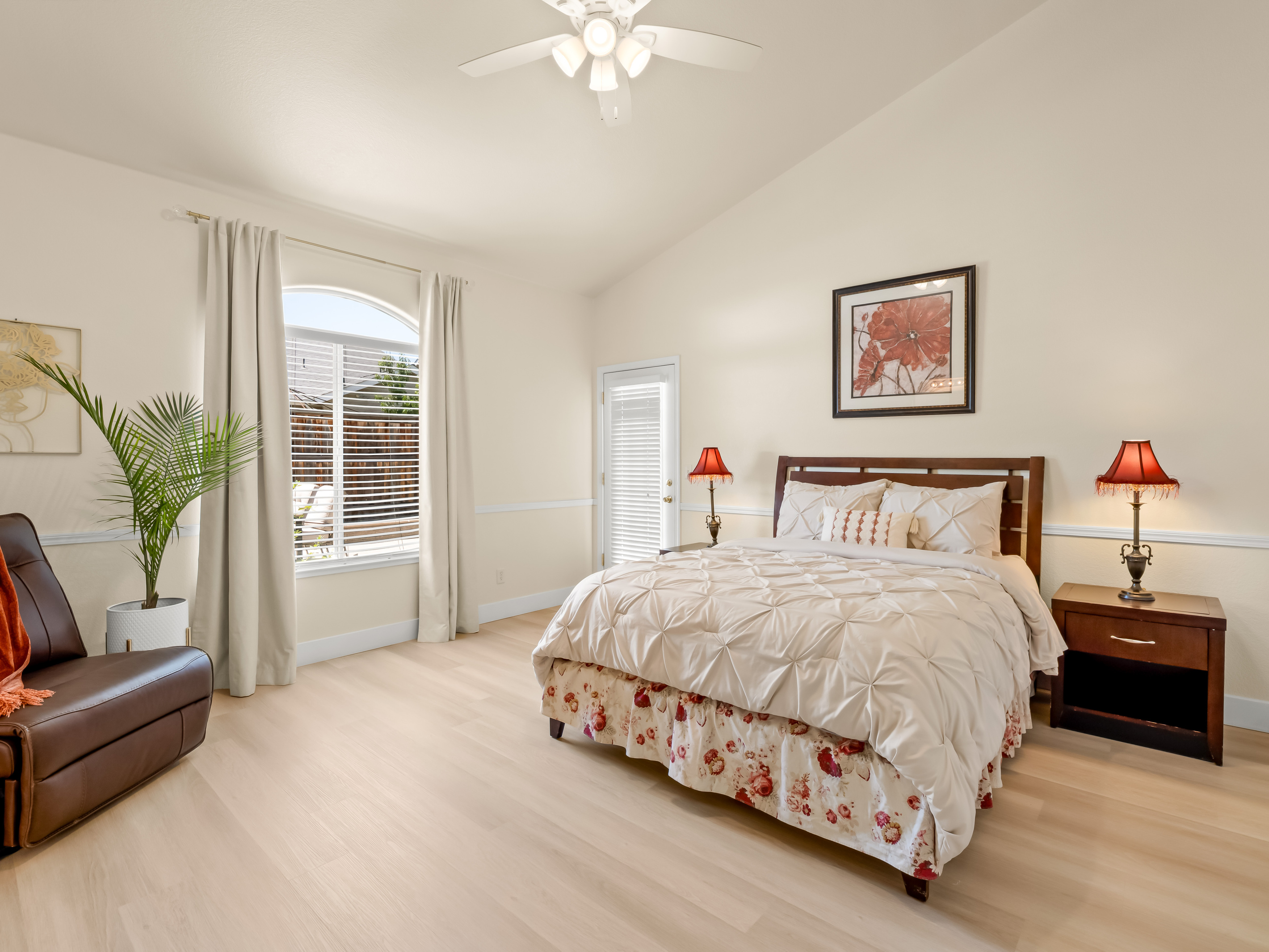 Retreat to this spacious primary suite featuring a plush bed, cozy recliner, and private access to the outdoor patio. Thoughtfully designed for comfort and relaxation, it's the perfect place to unwind after a day of exploring.