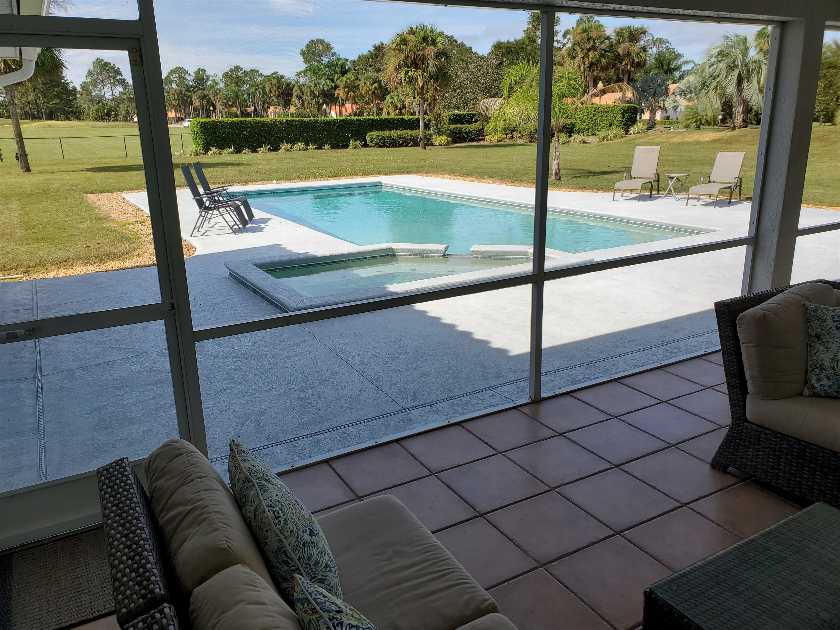 View of pool and backyard from Lanai