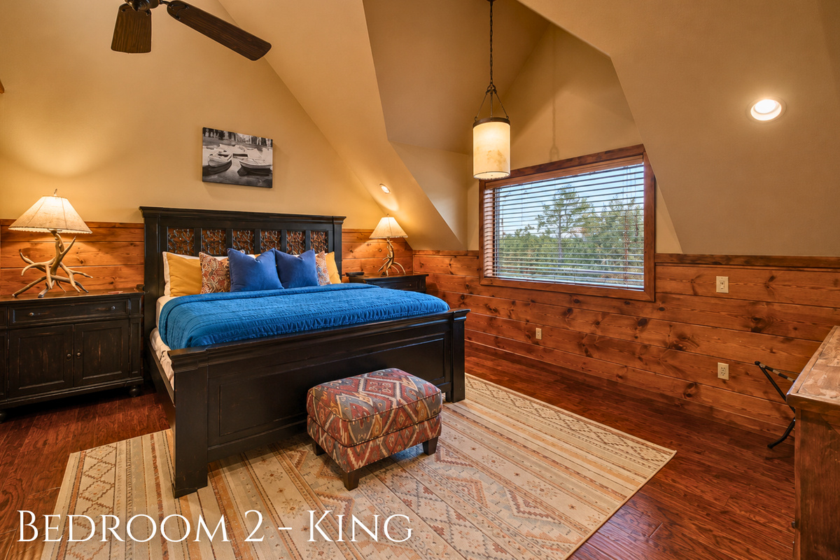Tucked beneath the angled ceiling, this king sleeping space feels especially cozy with rich blue bedding and plenty of room to settle in for the night.