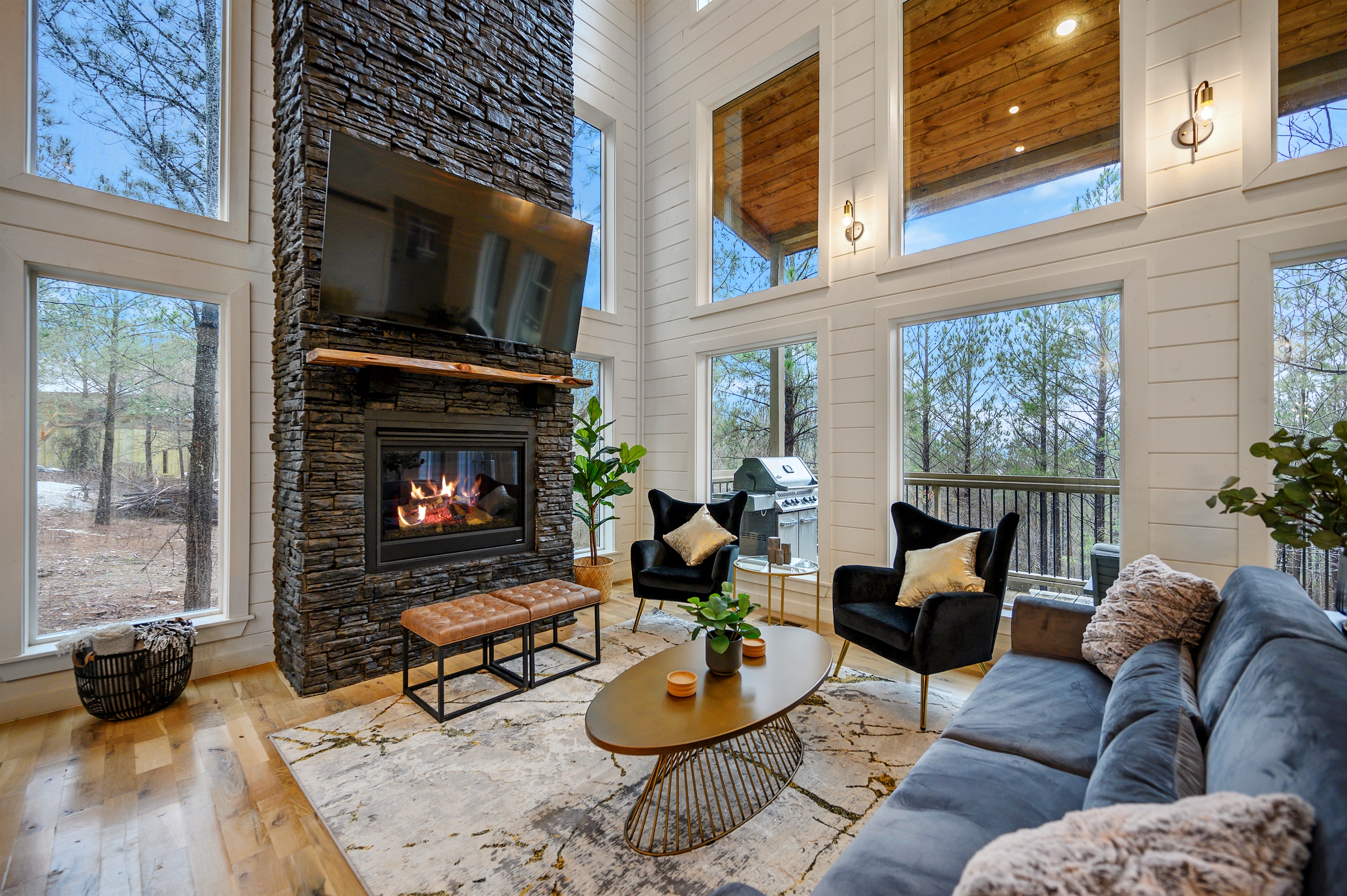 Stylish living area with inviting couches, warm fire feature, and TV for laid-back nights.