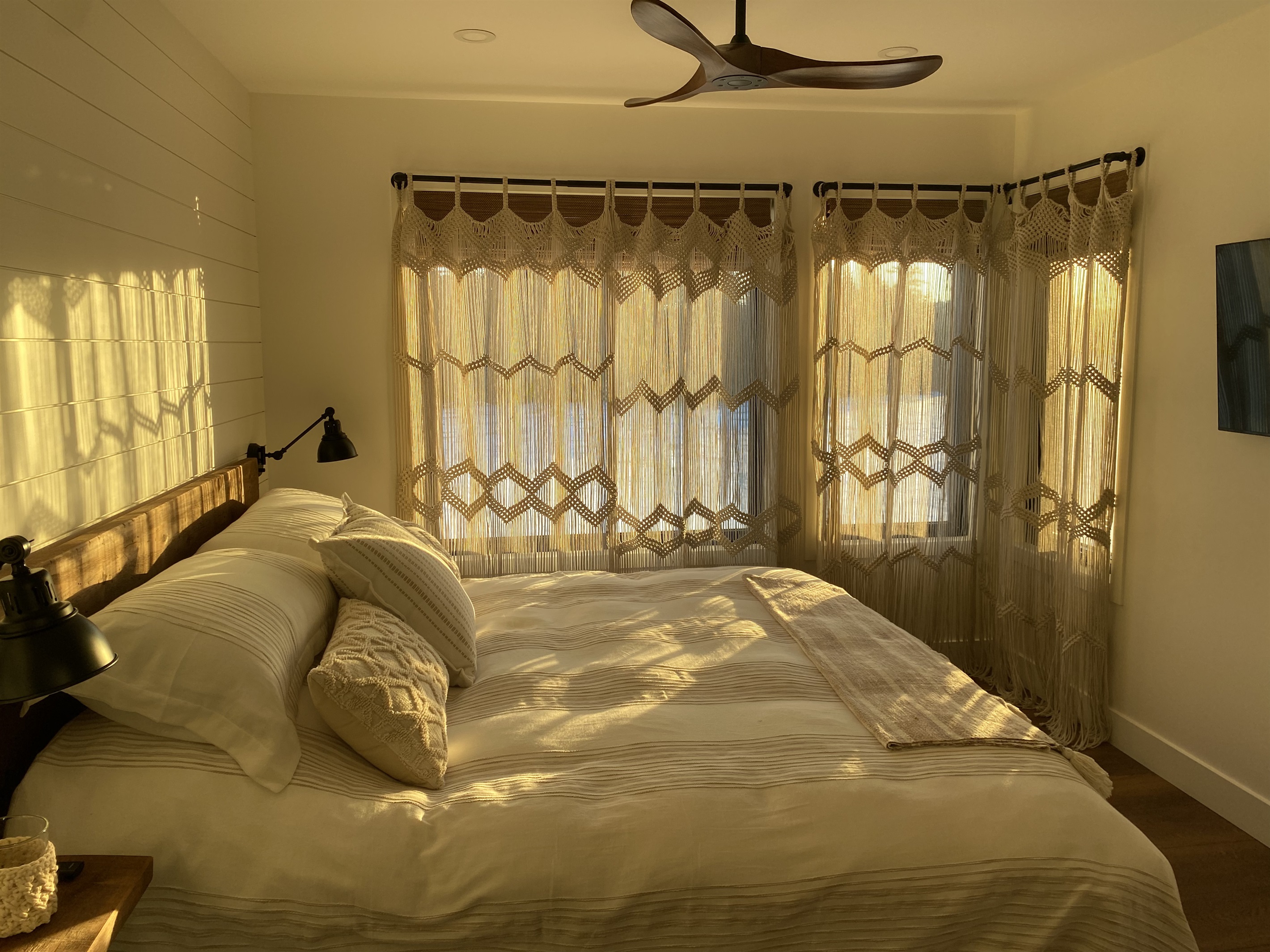 Main floor bedroom with king bed and drapes drawn
