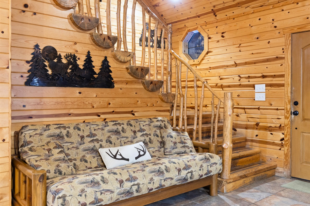 Cozy sitting area with futon and rustic decor touches.