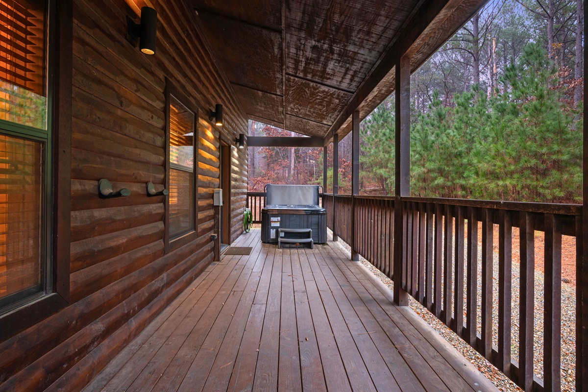 A long view of the deck shows plenty of space for lounging, dining, or simply enjoying the calm forest setting.