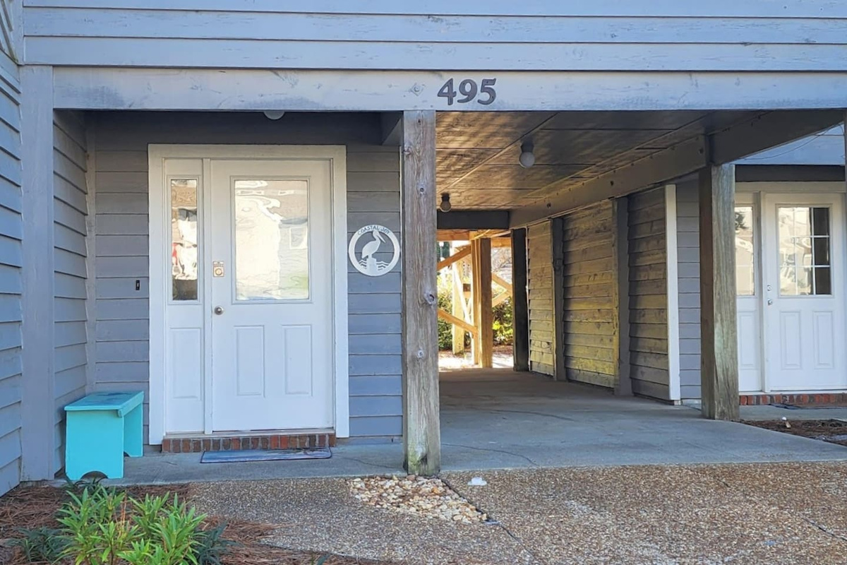 Pull up to 495 Barrier Dunes Drive &mdash; the covered carport is ready for your beach-gear-loaded car.