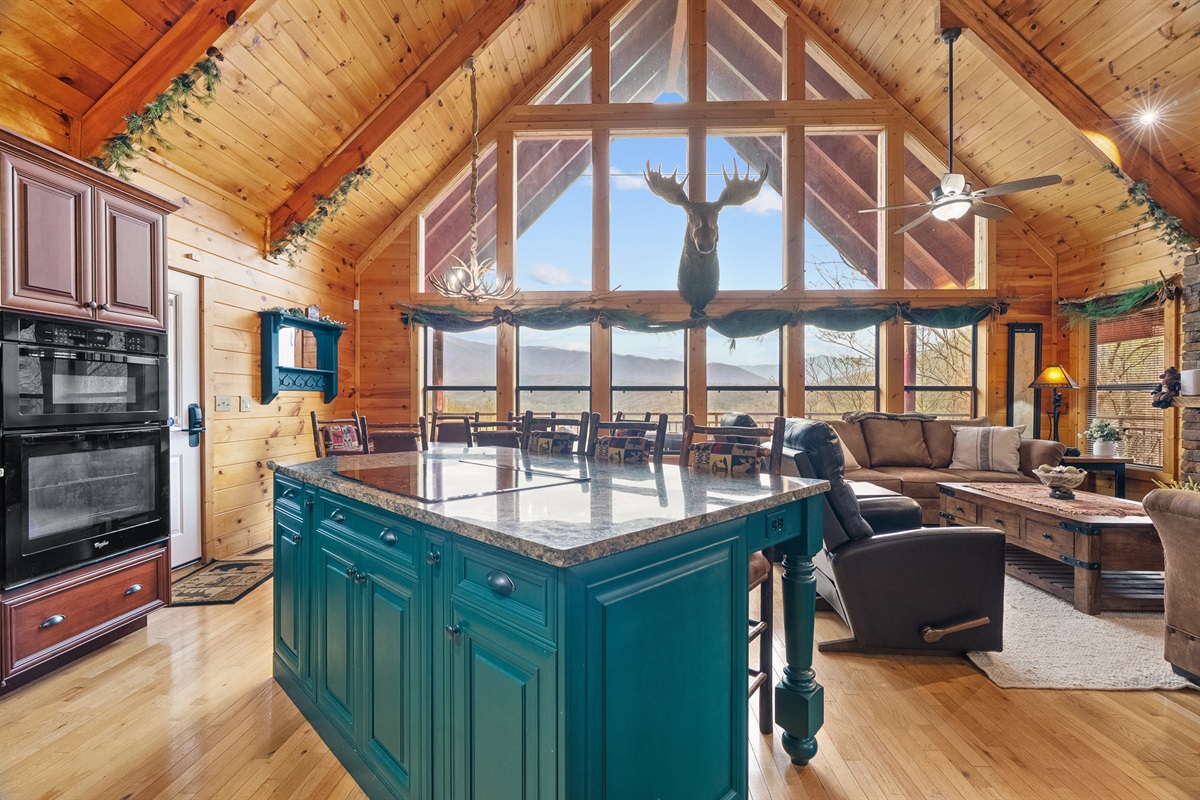 Wall-to-wall windows bring the mountains right into your living space.
Open-concept living with soaring ceilings and a true mountain lodge feel.