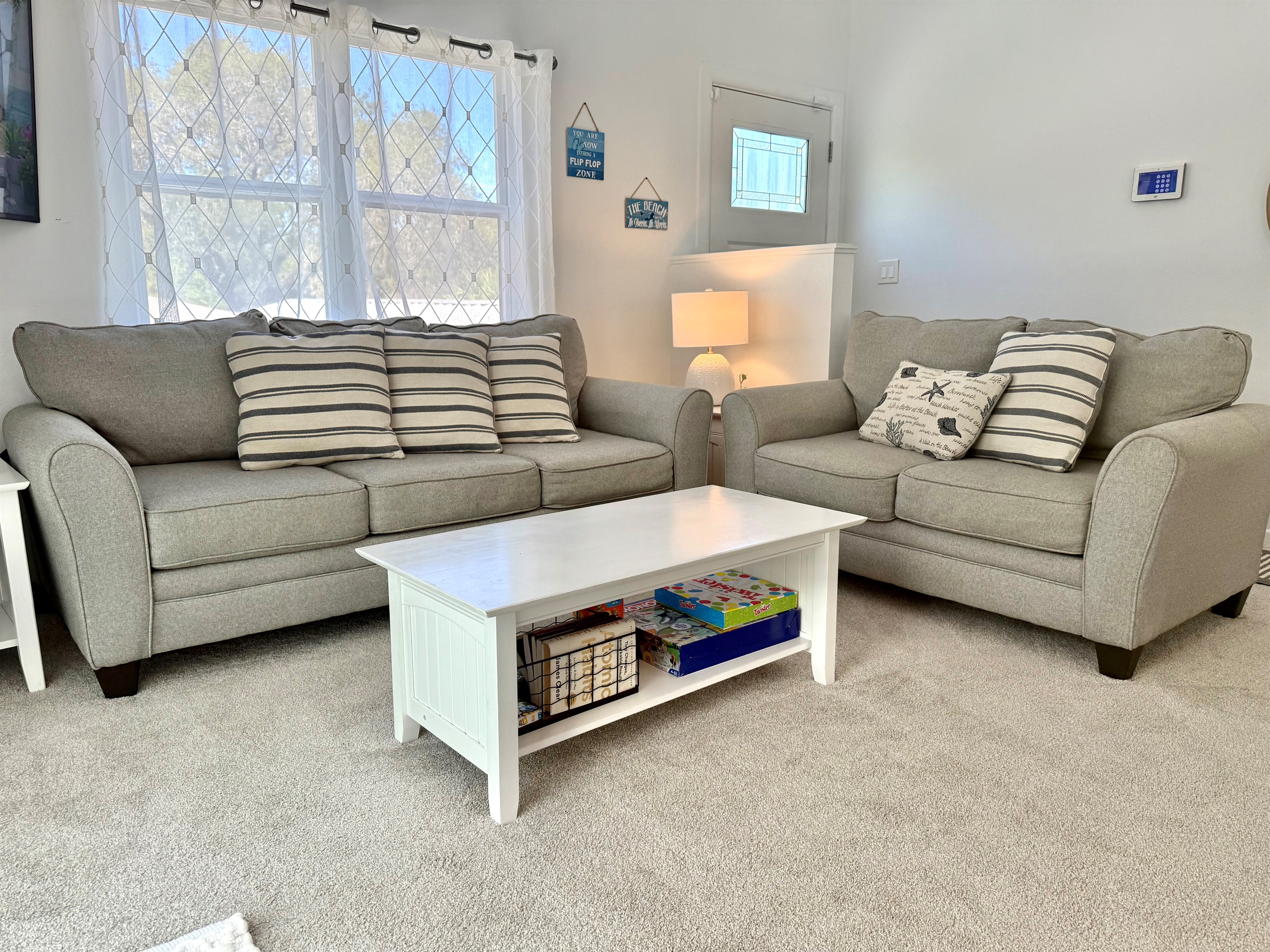 Step into this airy living room, featuring soft neutral tones, plush seating, and coastal-inspired décor that instantly puts you in vacation mode.