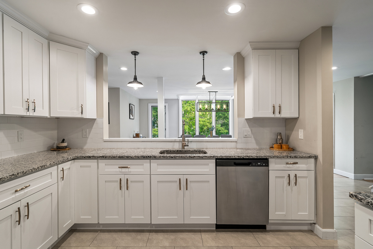 Kitchen peninsula with pendant lighting, a window over the sink and dishwasher for easy group cooking
