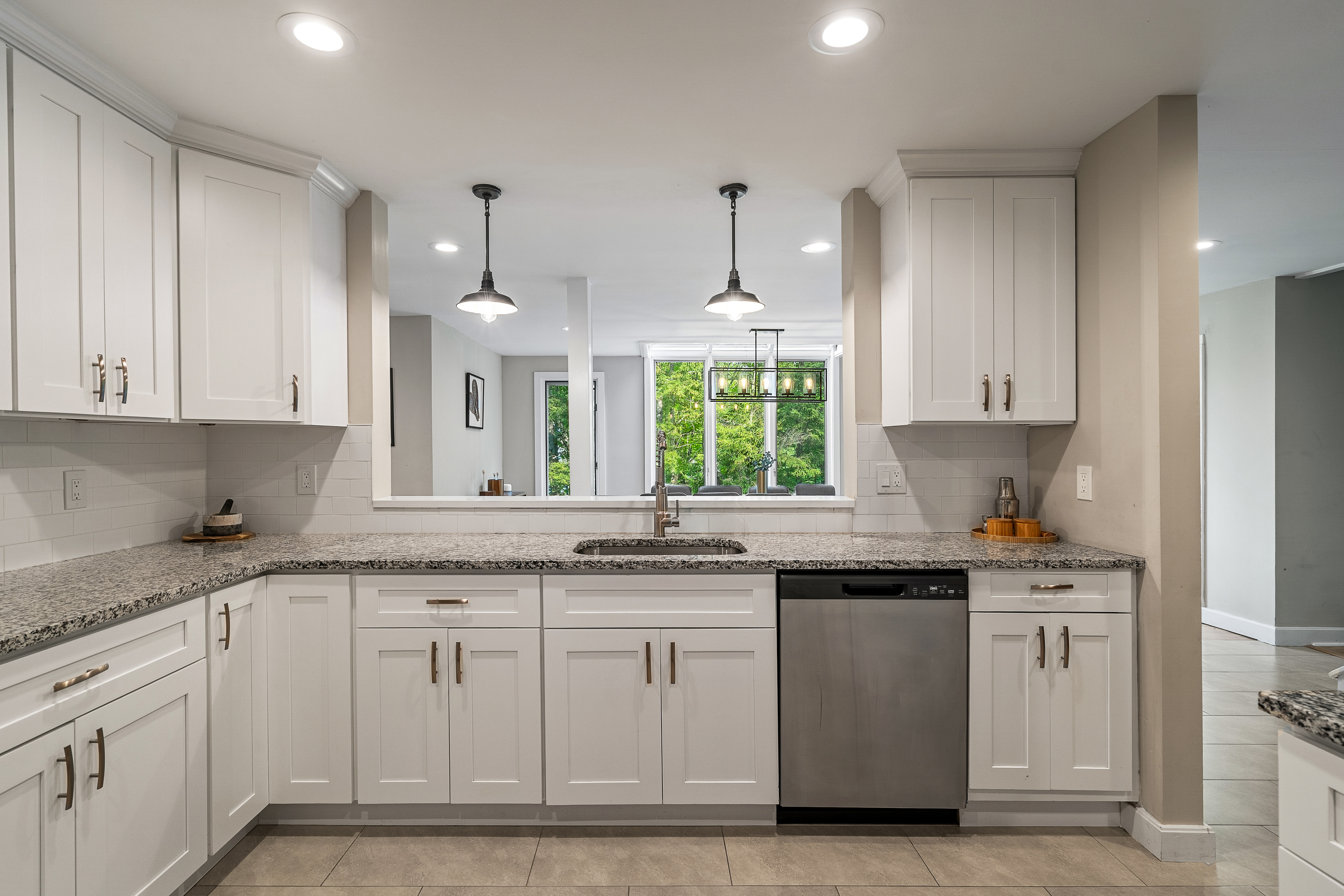 Kitchen peninsula with pendant lighting, a window over the sink and dishwasher for easy group cooking