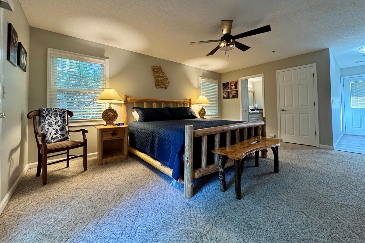 Relax in rustic comfort with a king-size bed, soft lighting, and cozy cabin charm. Step right out onto your private deck and enjoy the peaceful tree-lined views.