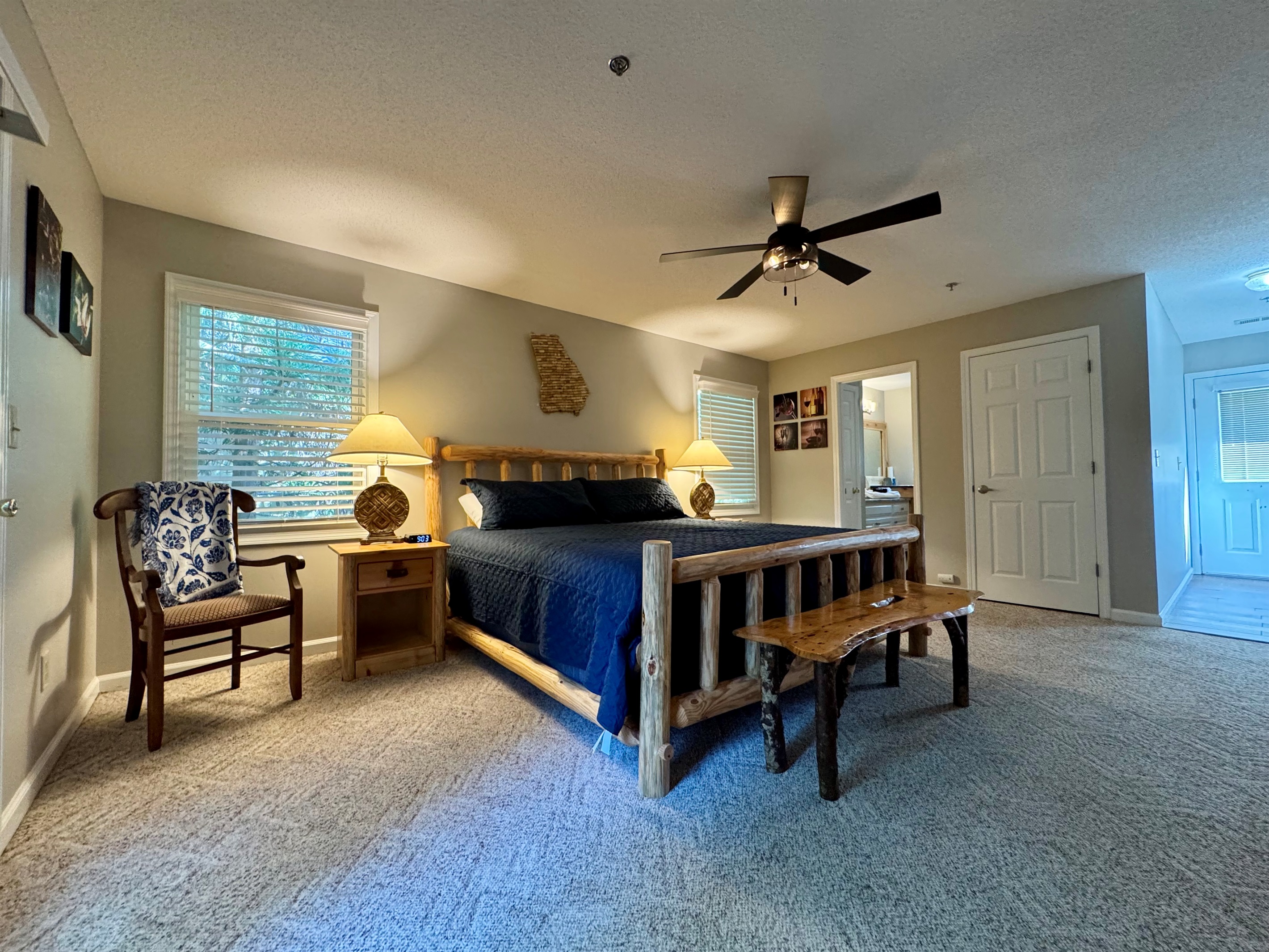 Relax in rustic comfort with a king-size bed, soft lighting, and cozy cabin charm. Step right out onto your private deck and enjoy the peaceful tree-lined views.