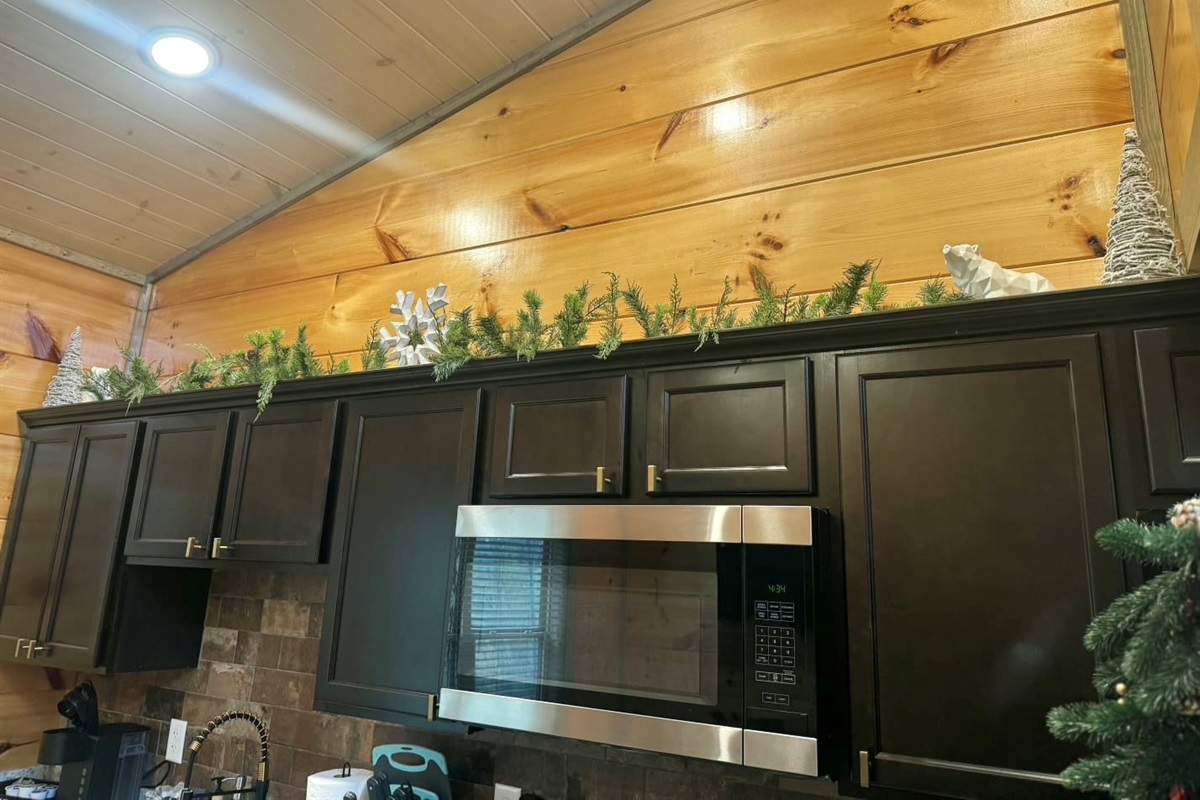 Feel the magic of the holidays in every corner as soft greenery crowns the kitchen, reminding you that simple touches can make a space feel like home.