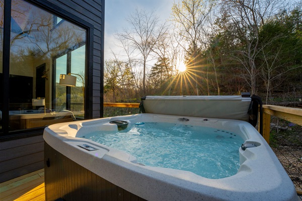 Soak under the trees and over the flowing creek as the forest settles into evening