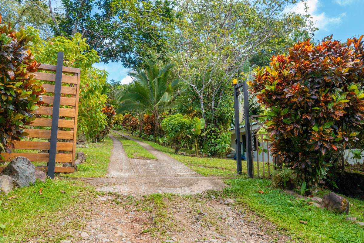 Gated property entrance — private road leading to Casa Infinity