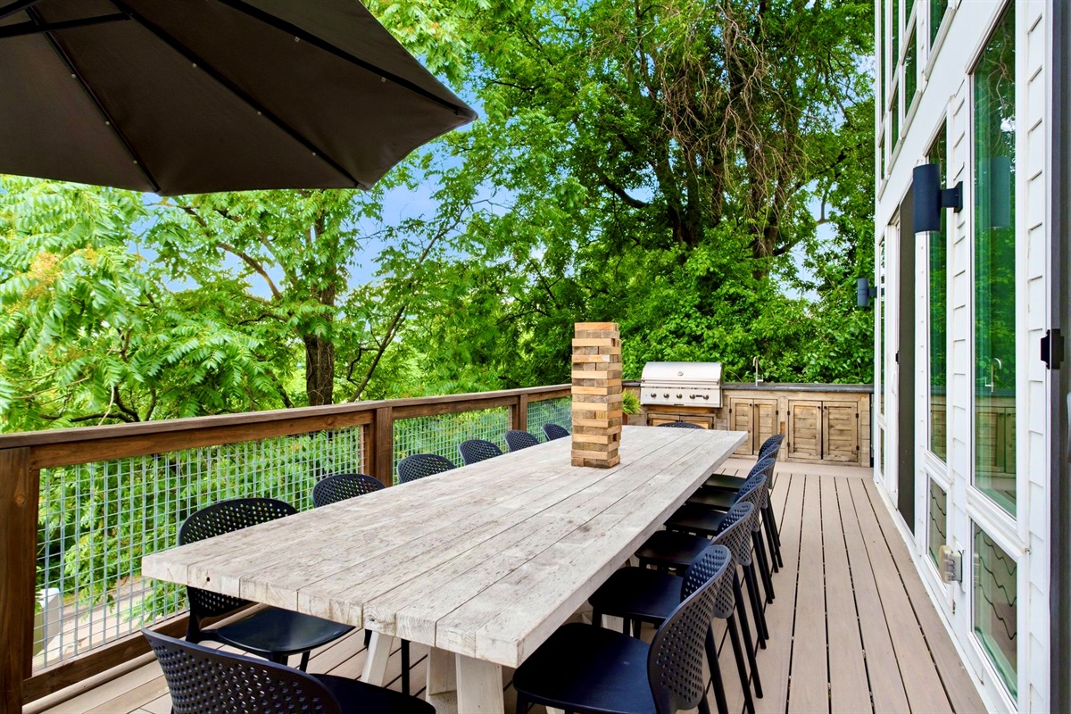 Deck dining table perched among the treetops — grab a drink & settle in for the evening.

