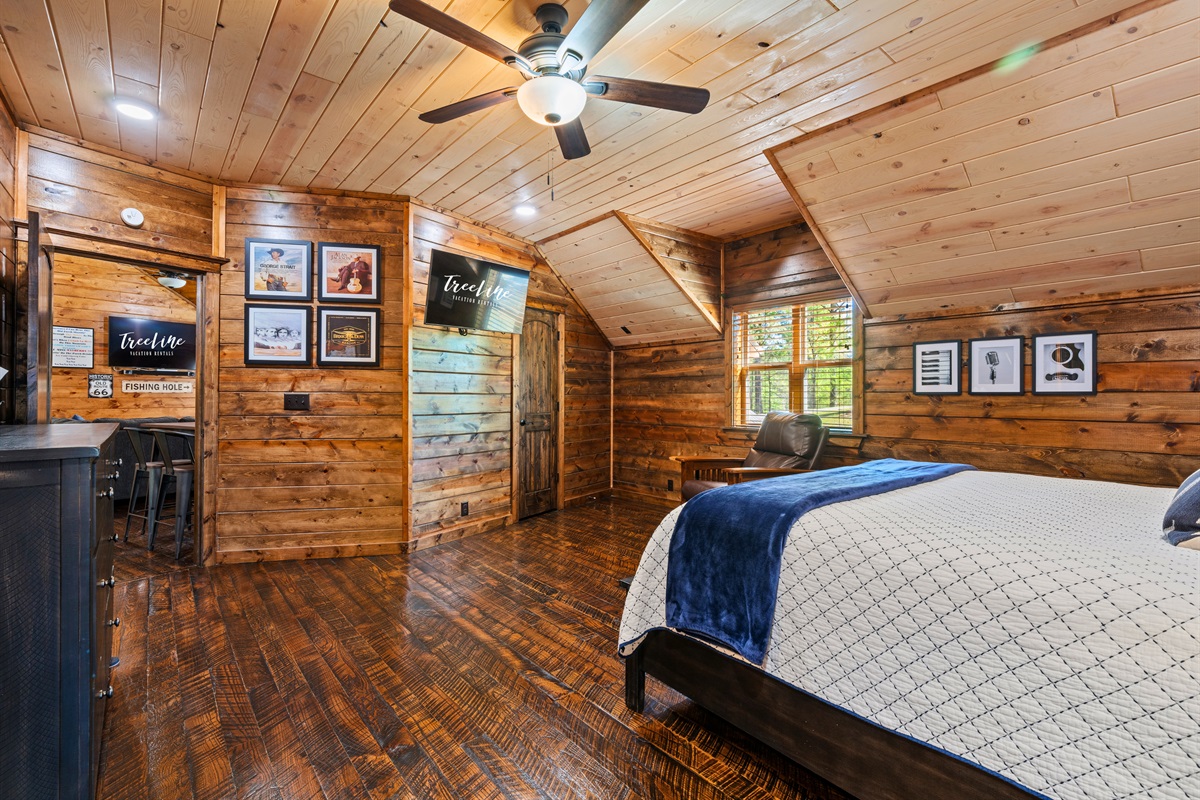 Another view of this spacious bedroom upstairs provides a relaxing atmosphere with plenty of room to unwind, making it a comfortable place to rest at the end of the day.
