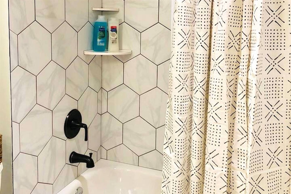 The second bathroom features charming honeycomb tiles and upgraded fixtures.