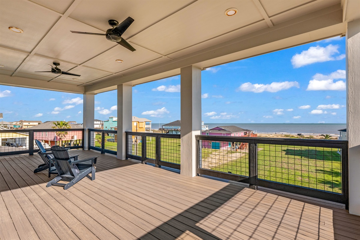 Costa Cristal Outdoor Space: Step out onto a spacious, covered balcony with ceiling fans for comfort and sweeping views of the ocean. Right off the second floor media room.