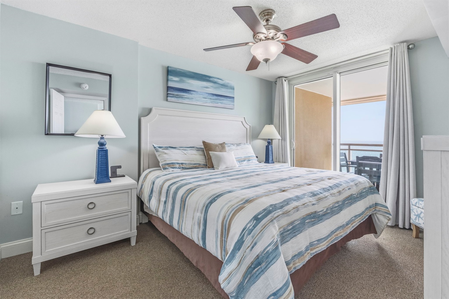 Primary Bedroom with King Bed, ensuite bathroom, and balcony with direct oceanview