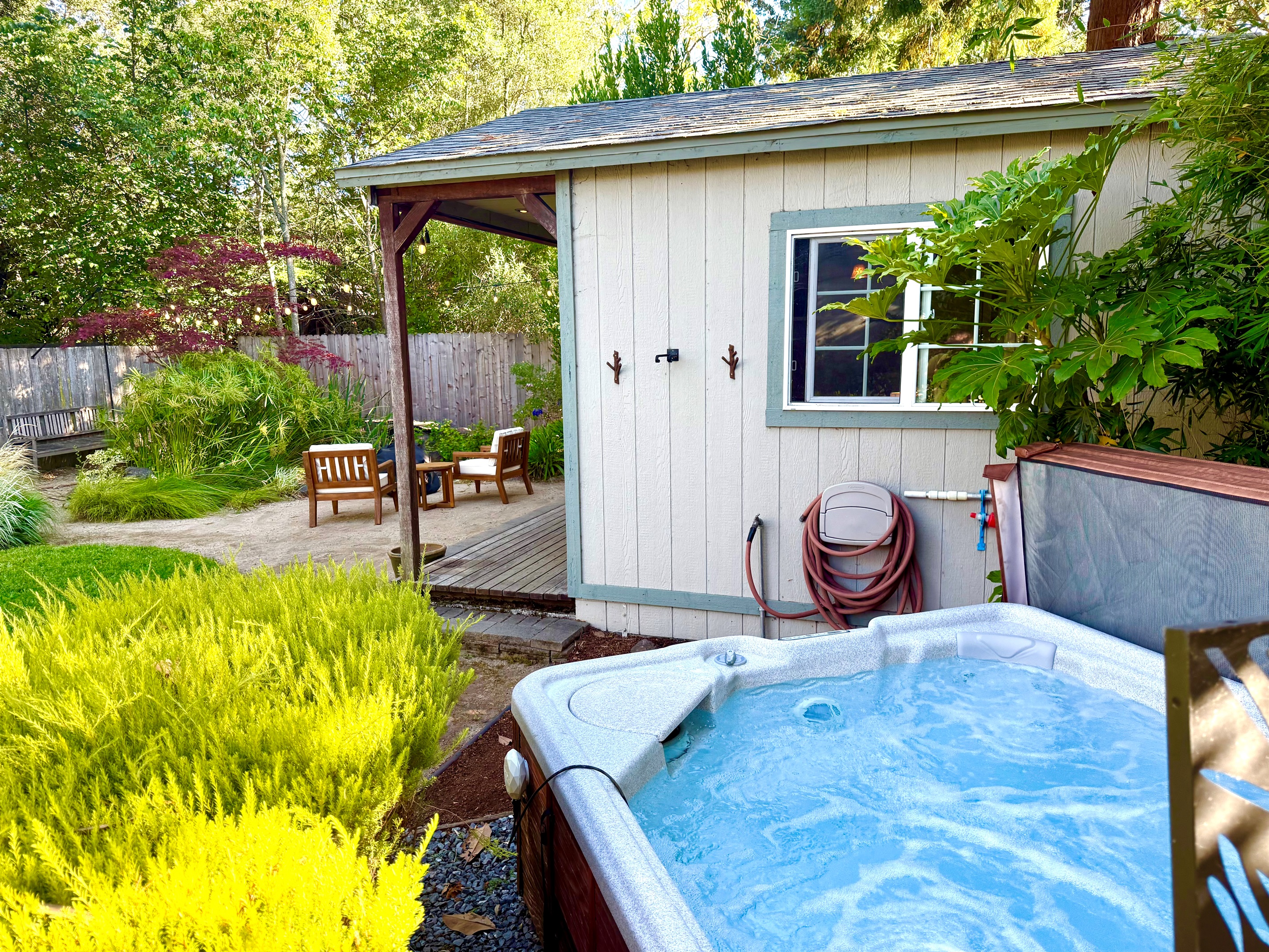 Private outdoor shower area wrapped in greenery
