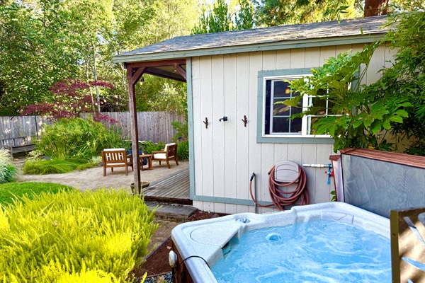 Private outdoor shower area wrapped in greenery