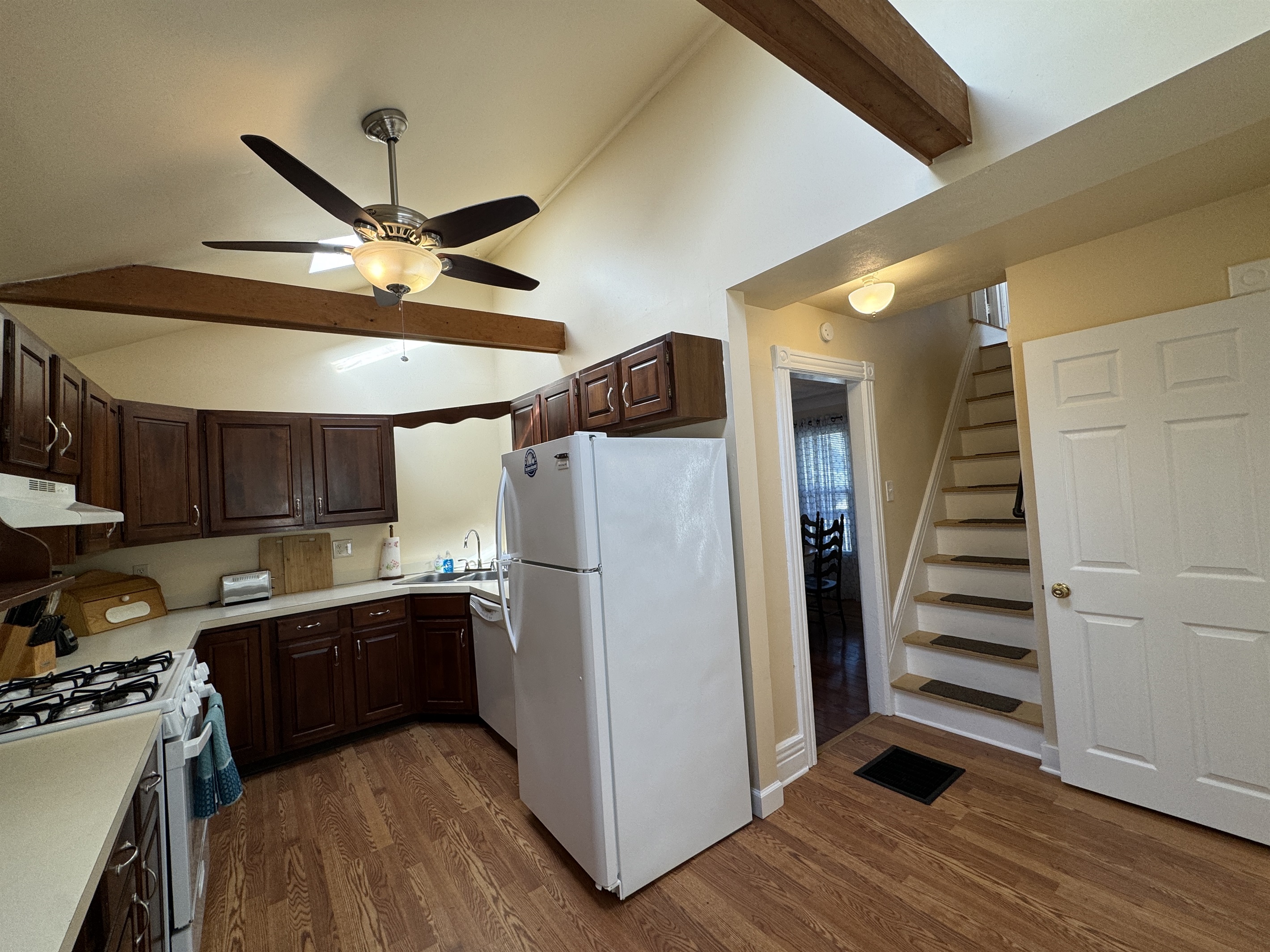 Cooperstown Cottage view from the kitchen into the dining room and the stairs leading to the 2nd floor bedrooms.
