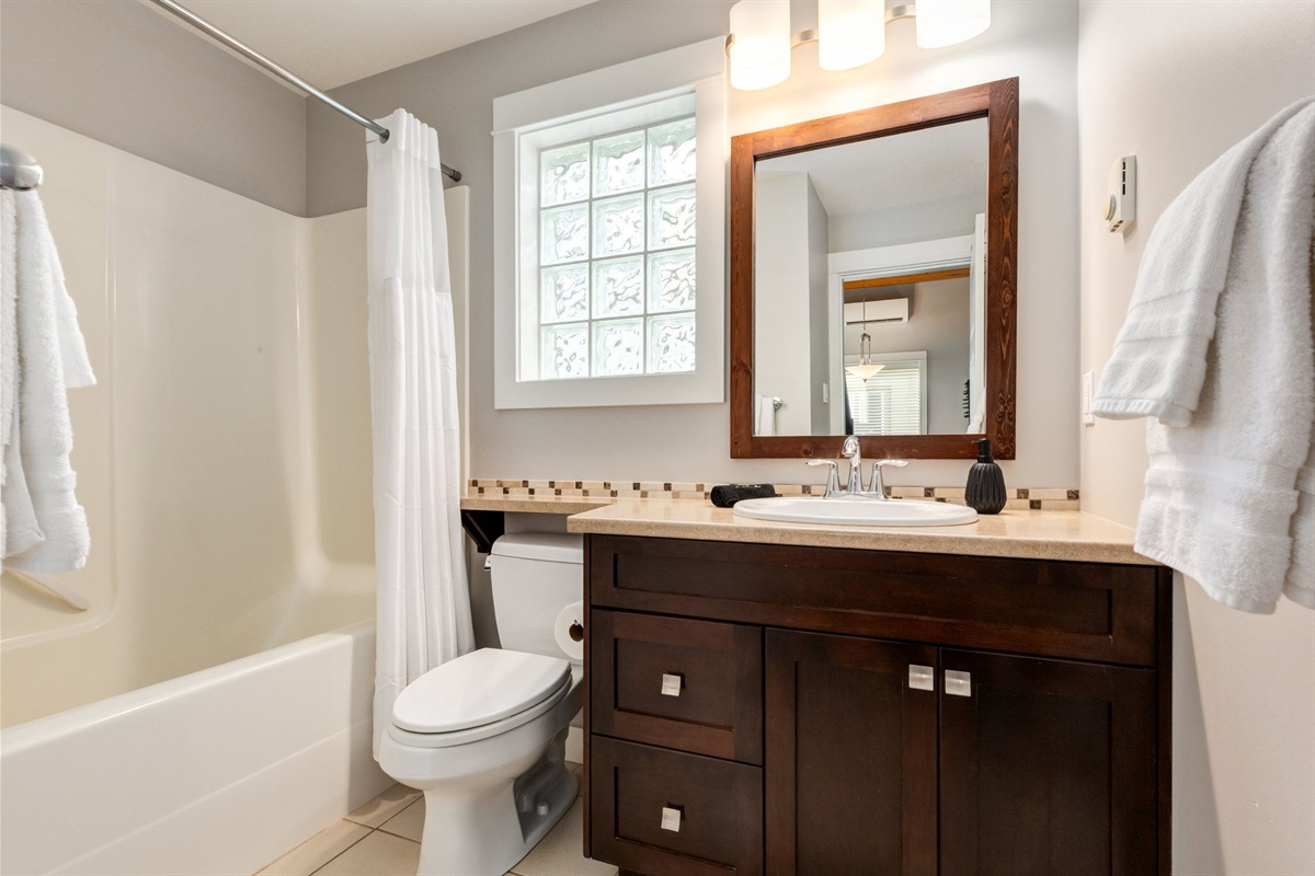 Full bathroom with fresh towels and essentials provided