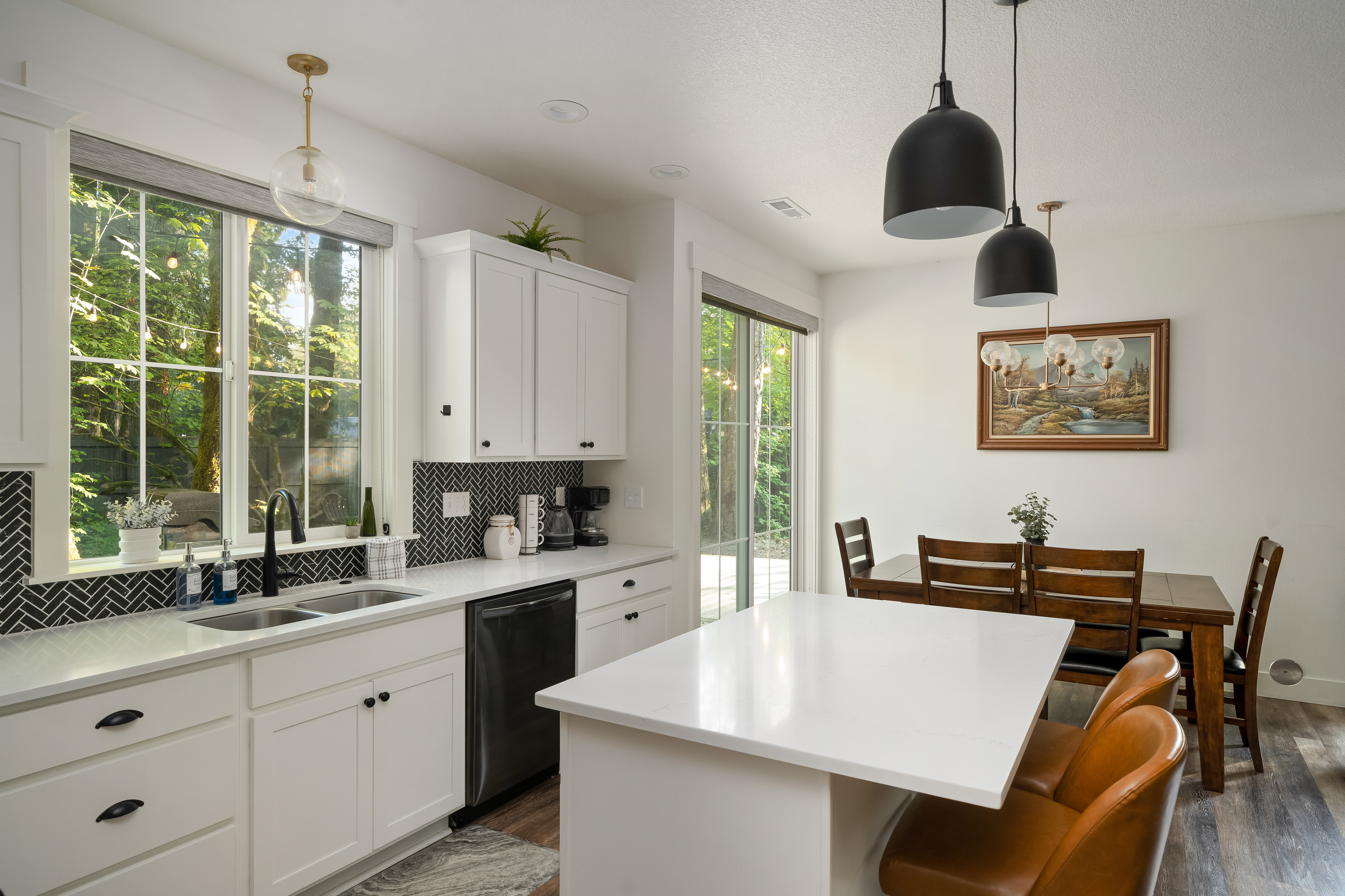 Island seating flows straight into the dining table — everyone's part of the conversation here.