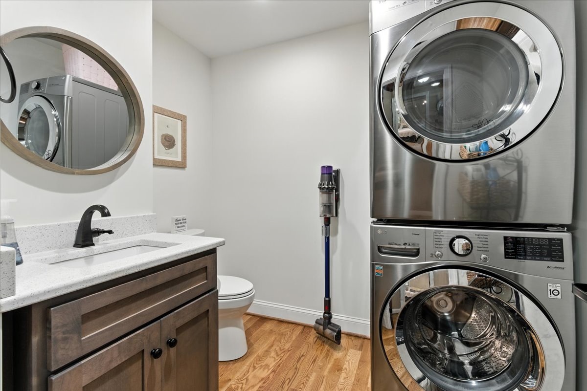 A half-bath and convenient laundry area, complete with a full-size stacking washer and dryer.