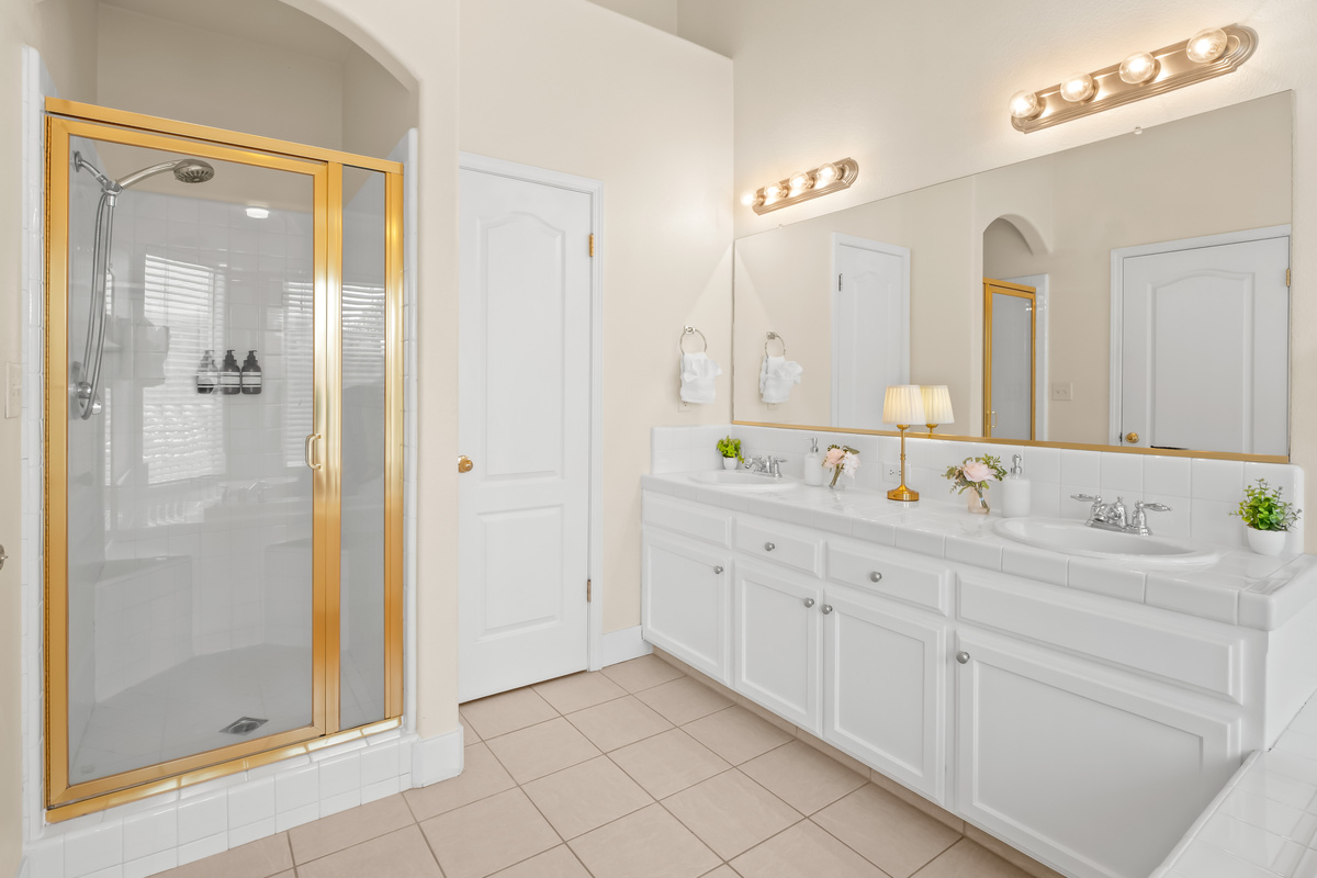 The spacious primary ensuite bathroom features dual vanities, a large walk-in shower, and plenty of room to get ready with ease. Bright, airy, and thoughtfully designed, it offers a comfortable retreat during your stay.