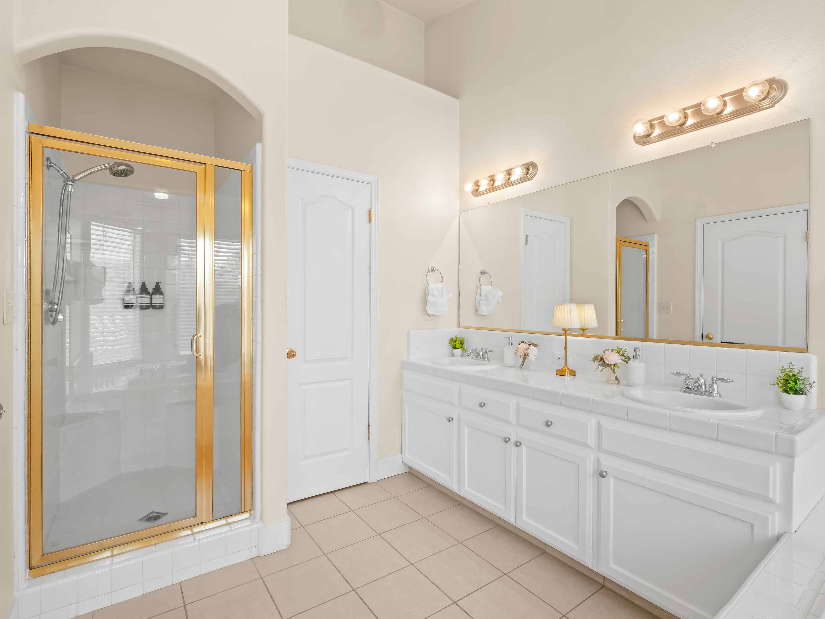 The spacious primary ensuite bathroom features dual vanities, a large walk-in shower, and plenty of room to get ready with ease. Bright, airy, and thoughtfully designed, it offers a comfortable retreat during your stay.